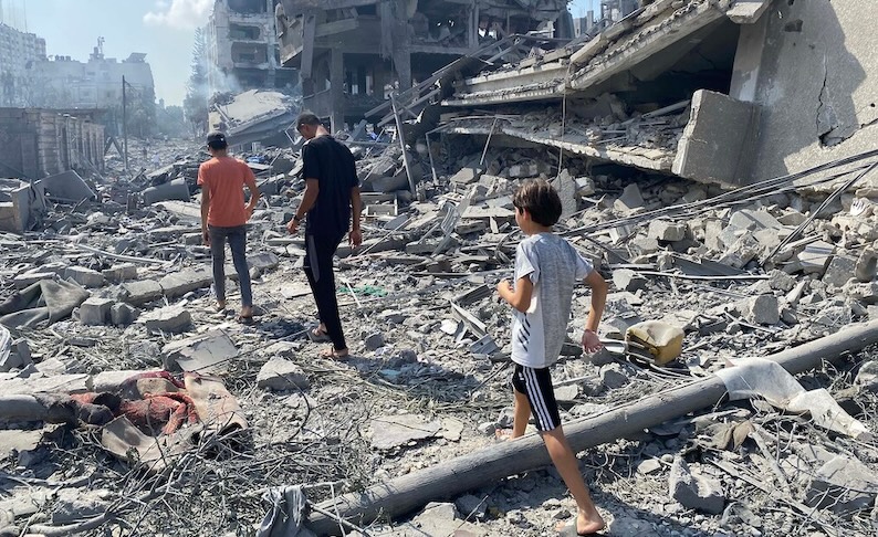 Children picking their way through rubble in Gaza. Gaza casualty data