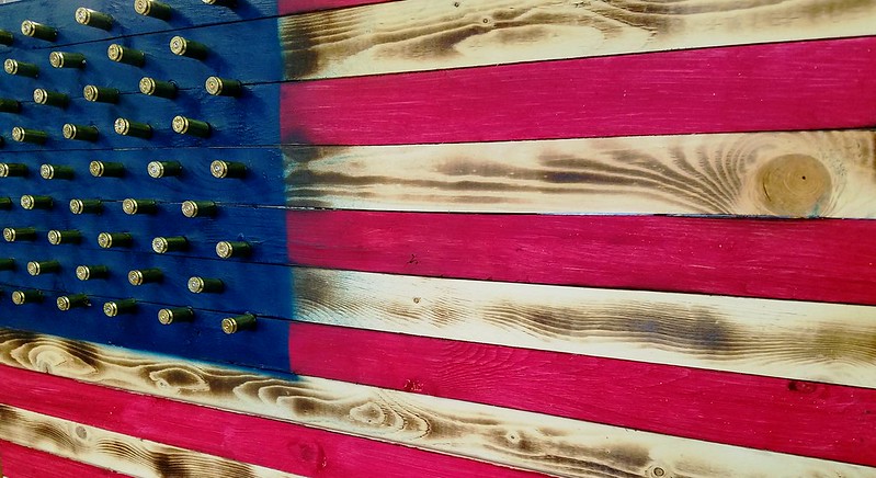Wooden US flag with bullets for stars (political violence)