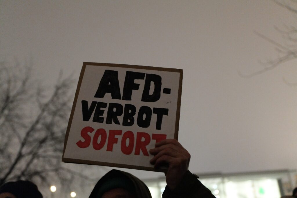 A protester at a march in Berlin on January 12, 2024 carries a sign that says AfD Verbot Sofort! This translates to "Ban AfD immediately," as thousands in Germany protest against the right-wing AfD's party and its reported goal of expelling thousands of foreigners living and working in Germany. 