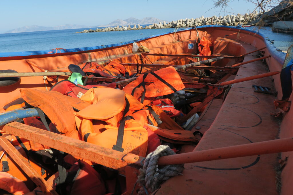 A lifeboat, filled with lifejackets, that was used to ferry migrants from Turkey to the Greek island of Samos. It is full with their lifejackets.