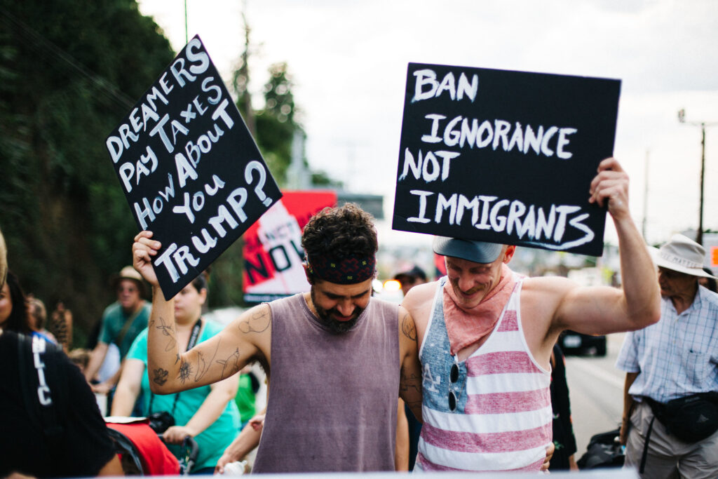 Will immigration be a key issue in November's election? Image shows two protesters in 2017 Los Angeles march in support of immigrant rights. 