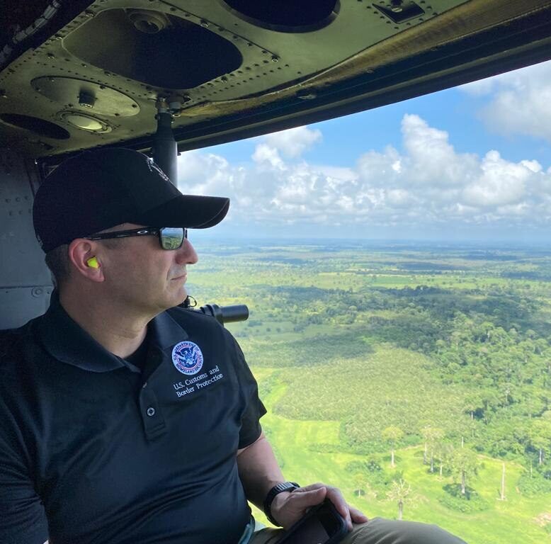 U.S. migration policies rely on Mexico, Panama, and other countries in Latin America to discourage migrants from heading north. Image shows U.S. border official in a helicopter over the Darien Province in Panama.