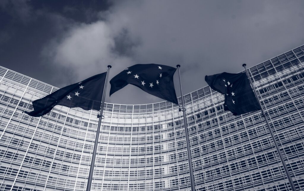 Can the E.U. tackle its own corruption problem? Image shows E.U. Commission building in Brussels, with European Union flags.