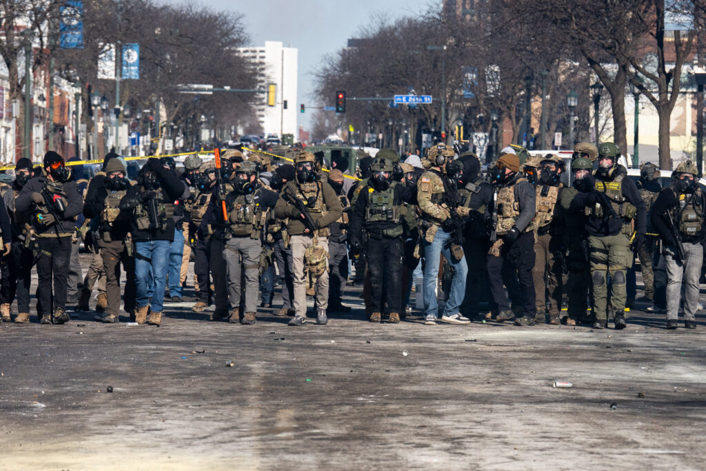 Image shows large number of armed ICE and Homeland Security agents blocking the road in Minneapolis, following the shooting death of protester Alex Pretti.