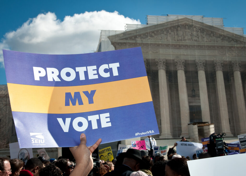 A protester's sign says "Protect My Vote," at a 2013 rally in front of the Supreme Court Building.
