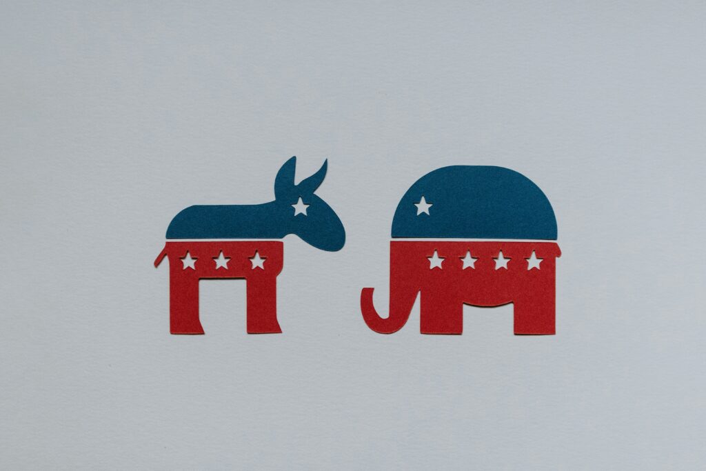 Can Democrats find the moderate middle? Image shows a Democratic donkey and GOP elephant facing each other.